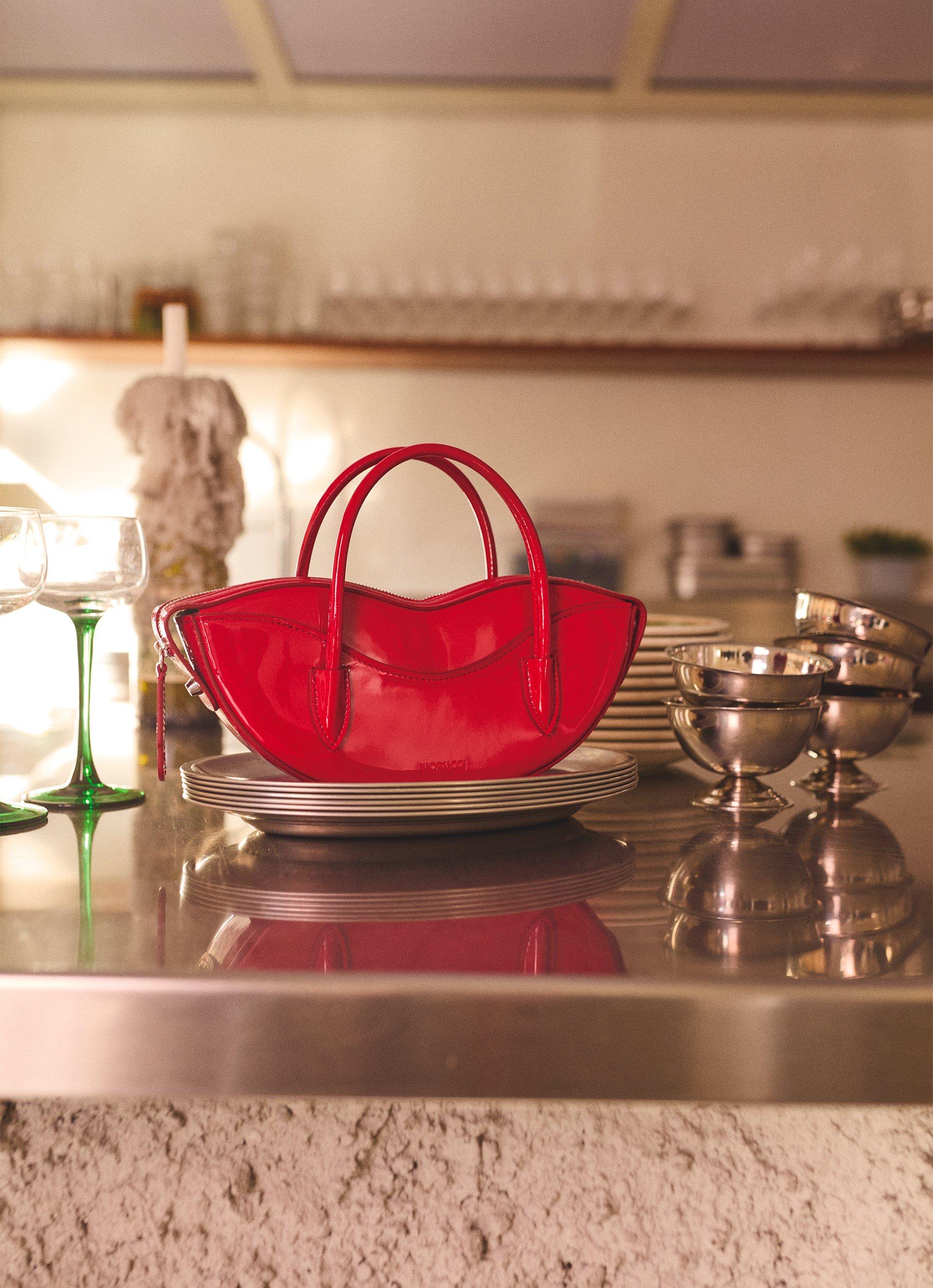 The picture features the Mini Lips Bag Vinyl in Red.